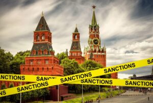 Sanctions caution tape at Moscow, Russia. Warning information on Kremlin background. Concept of economic sanctions against Russia, world crisis, Russi